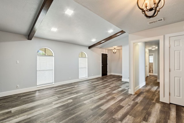 220 E Belton Ave, Rockdale, TX 76567 - unfurnished living room featuring beamed ceiling, a chandelier, dark wood-style floors, baseboards, and a textured ceiling