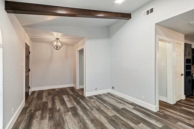 220 E Belton Ave, Rockdale, TX 76567 - unfurnished room featuring dark wood finished floors, baseboards, a chandelier, and beamed ceiling
