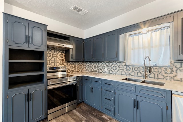 220 E Belton Ave, Rockdale, TX 76567 - kitchen with appliances with stainless steel finishes, extractor fan, a sink, dark wood finished floors, and tasteful backsplash