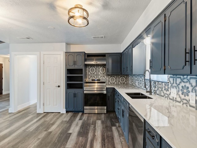 220 E Belton Ave, Rockdale, TX 76567 - kitchen featuring stainless steel appliances, a sink, a textured ceiling, backsplash, and dark wood-type flooring