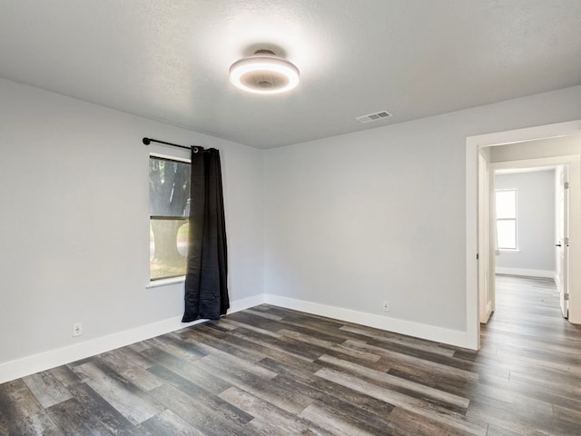 220 E Belton Ave, Rockdale, TX 76567 - empty room featuring dark wood finished floors and baseboards