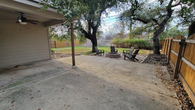 1002 Boxwood Loop, Georgetown, TX 78628 - fenced backyard with ceiling fan, a patio area, and a fire pit