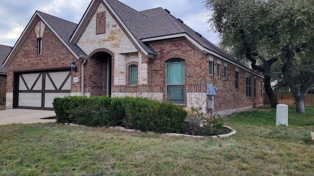 1002 Boxwood Loop, Georgetown, TX 78628 - view of front facade with brick siding, stone siding, roof with shingles, and driveway