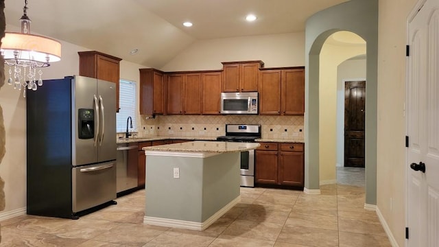 1002 Boxwood Loop, Georgetown, TX 78628 - kitchen with stainless steel appliances, a sink, backsplash, a kitchen island, and arched walkways