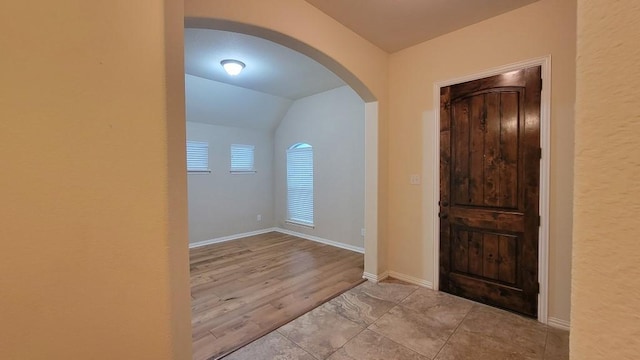 1002 Boxwood Loop, Georgetown, TX 78628 - foyer entrance featuring arched walkways, vaulted ceiling, and baseboards