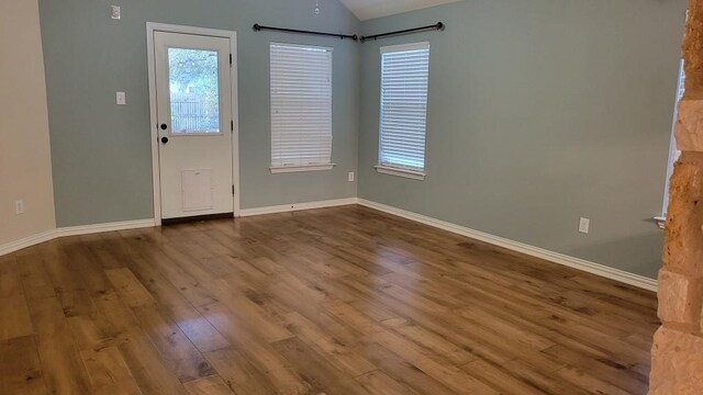1002 Boxwood Loop, Georgetown, TX 78628 - unfurnished room featuring wood finished floors, baseboards, plenty of natural light, and vaulted ceiling