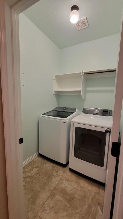 1002 Boxwood Loop, Georgetown, TX 78628 - washroom featuring separate washer and dryer and baseboards
