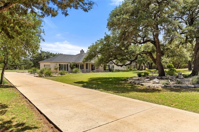 14717 Crosscreek Dr, Austin, TX 78737 - view of front of house featuring a garage, a front lawn, a chimney, and concrete driveway