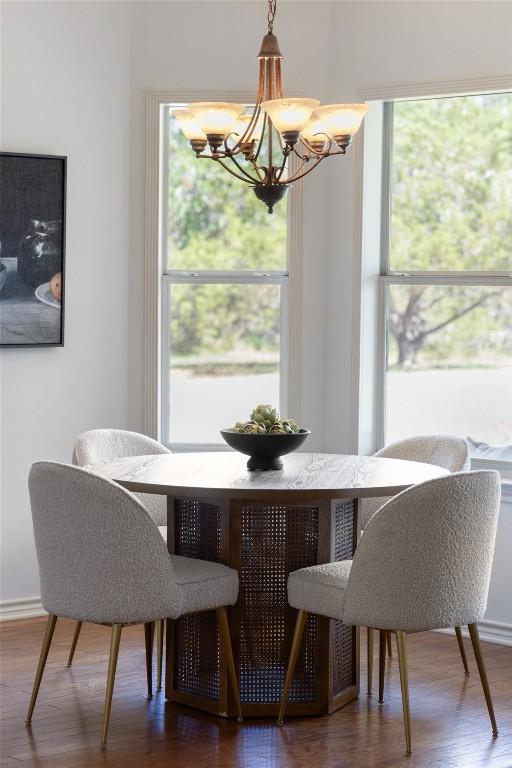 14717 Crosscreek Dr, Austin, TX 78737 - dining space featuring a chandelier, wood finished floors, and baseboards