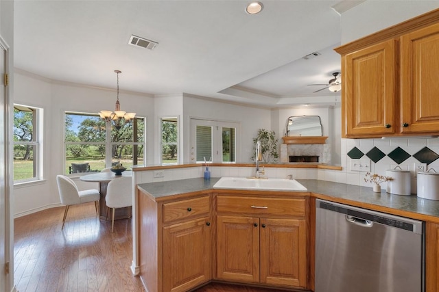 14717 Crosscreek Dr, Austin, TX 78737 - kitchen featuring stainless steel dishwasher, a peninsula, a sink, backsplash, and a chandelier