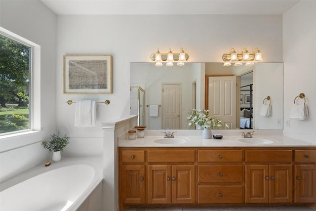 14717 Crosscreek Dr, Austin, TX 78737 - bathroom with double vanity, a garden tub, and a shower with door