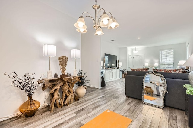 1521 W Kerr Pass, Leander, TX 78641 - living room featuring light wood-style flooring and a chandelier