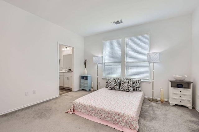 1521 W Kerr Pass, Leander, TX 78641 - carpeted bedroom with baseboards and connected bathroom
