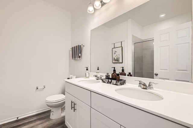 1521 W Kerr Pass, Leander, TX 78641 - full bathroom featuring a stall shower, double vanity, and wood finished floors