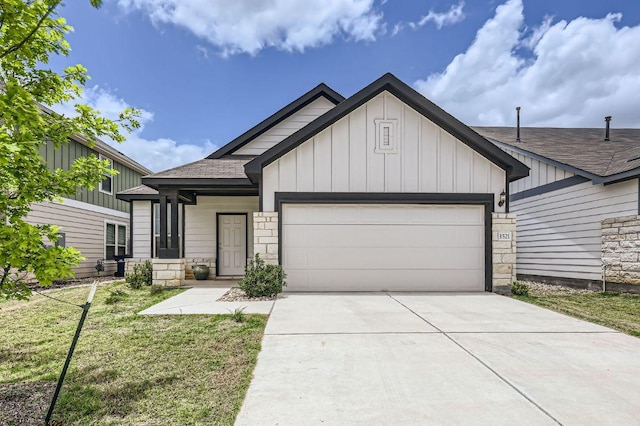 1521 W Kerr Pass, Leander, TX 78641 - view of front of property with a shingled roof, a garage, concrete driveway, a front yard, and board and batten siding
