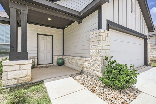 1521 W Kerr Pass, Leander, TX 78641 - property entrance featuring board and batten siding, stone siding, a garage, covered porch, and driveway