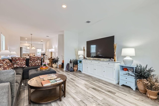 1521 W Kerr Pass, Leander, TX 78641 - living area with light wood-style flooring, a chandelier, and recessed lighting