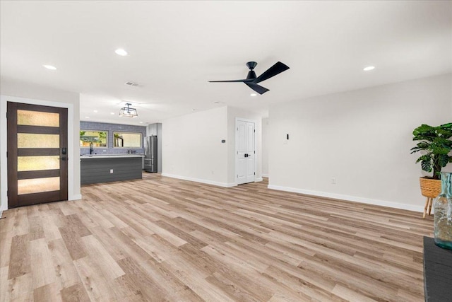 9717 Anderson Village Dr, Austin, TX 78729 - unfurnished living room featuring light wood-style flooring, recessed lighting, and ceiling fan