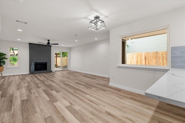 9717 Anderson Village Dr, Austin, TX 78729 - unfurnished living room featuring light wood-type flooring, a fireplace, recessed lighting, and ceiling fan