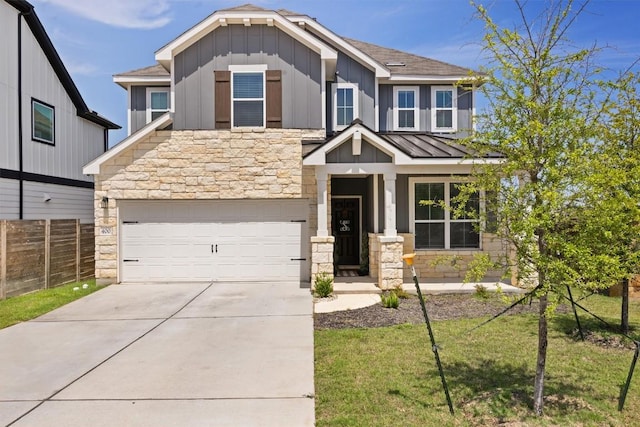 400 Turnbuckle Bnd, Leander, TX 78641 - craftsman-style home featuring stone siding, board and batten siding, concrete driveway, a shingled roof, and a standing seam roof