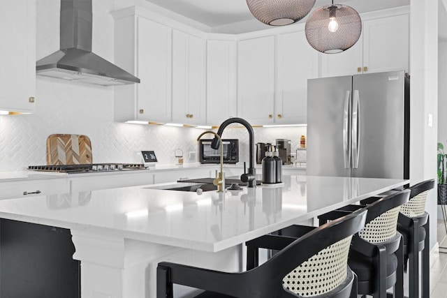 400 Turnbuckle Bnd, Leander, TX 78641 - kitchen with wall chimney exhaust hood, stainless steel appliances, decorative backsplash, white cabinets, and a breakfast bar