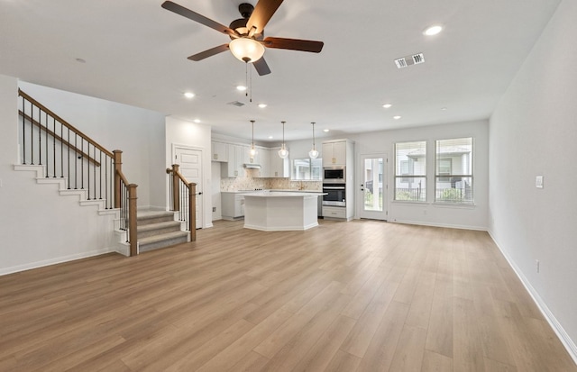 2725 Woodall Dr Unit 1601, Cedar Park, TX 78613 - unfurnished living room with baseboards, a ceiling fan, light wood-style floors, stairway, and recessed lighting