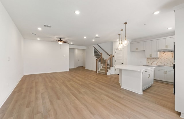 2725 Woodall Dr Unit 1601, Cedar Park, TX 78613 - kitchen with recessed lighting, a center island, a ceiling fan, backsplash, and light wood-style floors