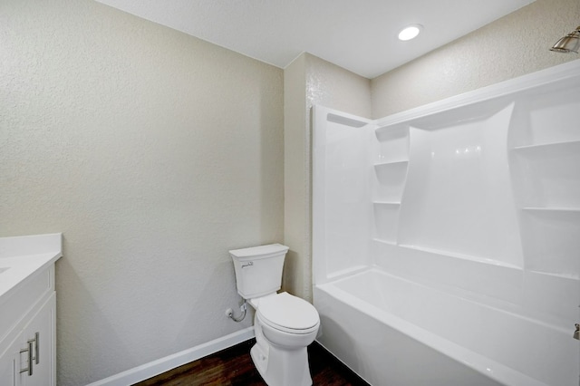 212 Walnut Ave, Luling, TX 78648 - full bathroom with wood finished floors, vanity, a textured wall, and shower / tub combination