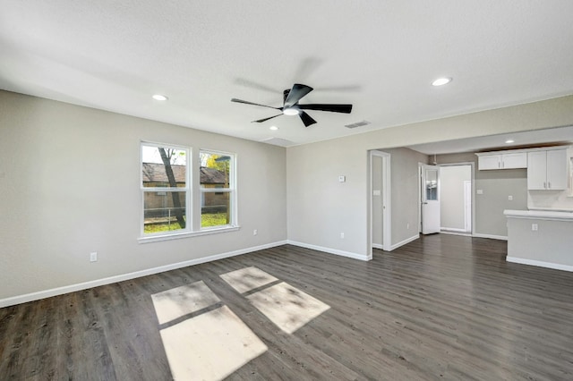 212 Walnut Ave, Luling, TX 78648 - unfurnished living room with dark wood-style floors, a ceiling fan, and recessed lighting
