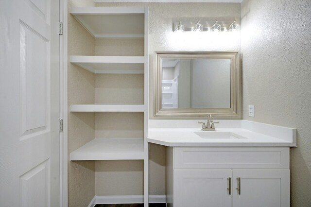 212 Walnut Ave, Luling, TX 78648 - bathroom with vanity and a textured wall