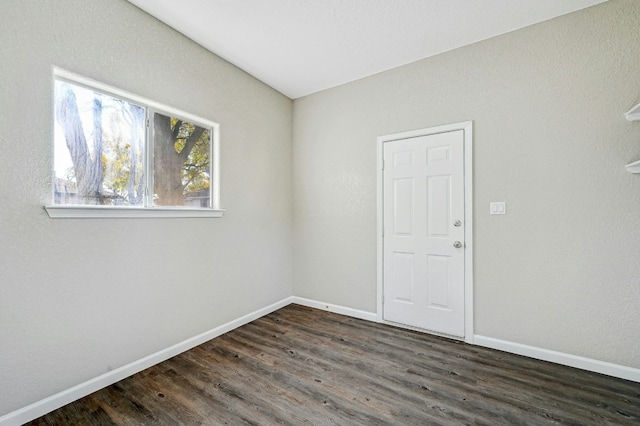 212 Walnut Ave, Luling, TX 78648 - spare room featuring baseboards and dark wood finished floors