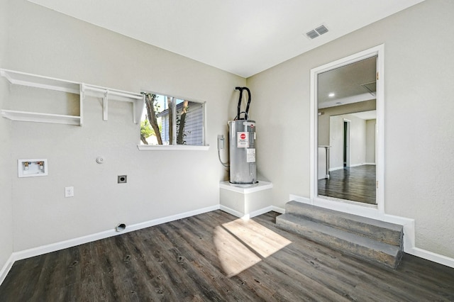 212 Walnut Ave, Luling, TX 78648 - laundry room featuring electric water heater, electric dryer hookup, hookup for a washing machine, wood finished floors, and gas dryer hookup