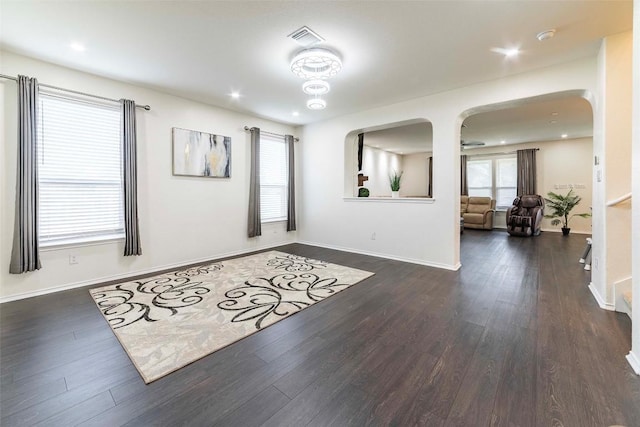 1224 Euless Ln, Leander, TX 78641 - unfurnished room featuring arched walkways, dark wood-style floors, a smoke detector, and recessed lighting