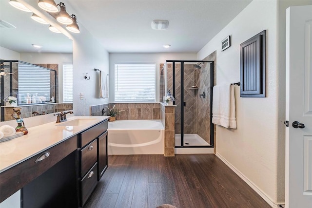 1224 Euless Ln, Leander, TX 78641 - bathroom with wood finished floors, a bath, vanity, and a stall shower