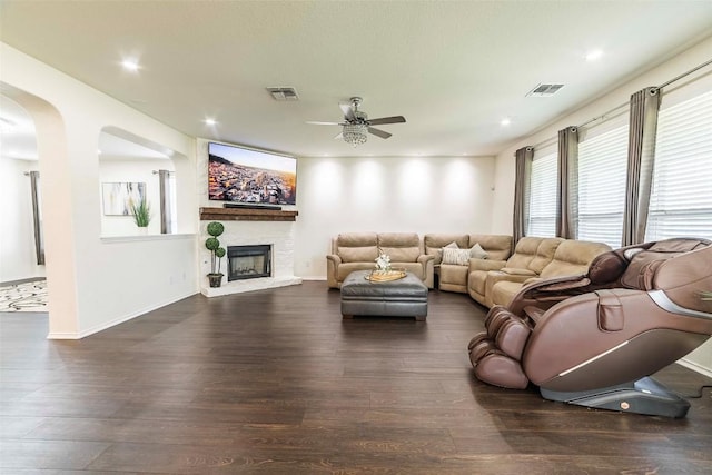 1224 Euless Ln, Leander, TX 78641 - living area with ceiling fan, wood finished floors, arched walkways, recessed lighting, and a fireplace