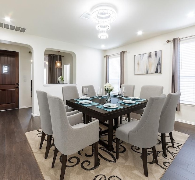 1224 Euless Ln, Leander, TX 78641 - dining area featuring arched walkways, wood finished floors, and recessed lighting