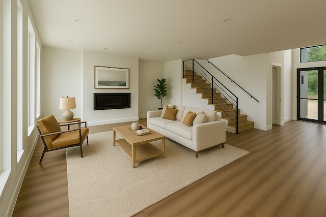2404 Big Horn Dr, Austin, TX 78734 - living room featuring stairway, wood finished floors, and a glass covered fireplace