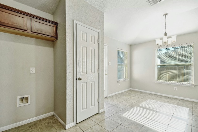 121 Talon Dr, Luling, TX 78648 - unfurnished dining area featuring a chandelier, light tile patterned flooring, and baseboards