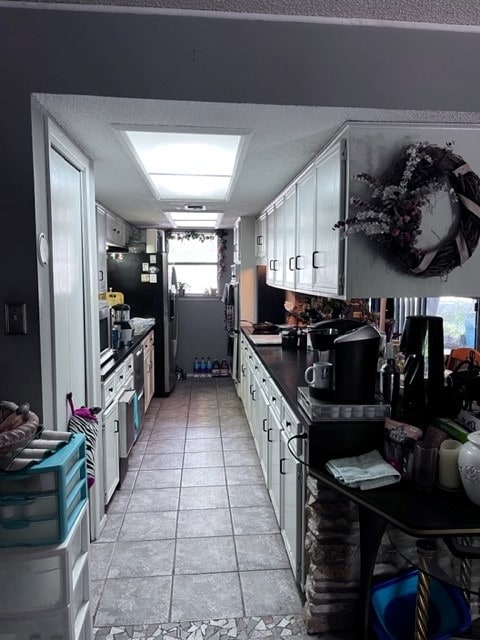 4605 Eck Ln, Austin, TX 78734 - kitchen with dark countertops, white cabinets, and stainless steel appliances