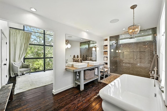 1700 S 6th St, Austin, TX 78704 - bathroom with a freestanding bath, a shower stall, wood finished floors, baseboards, and vanity