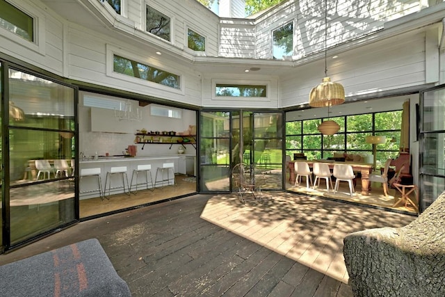 1700 S 6th St, Austin, TX 78704 - sunroom / solarium with a deck, a towering ceiling, hardwood / wood-style flooring, and a skylight