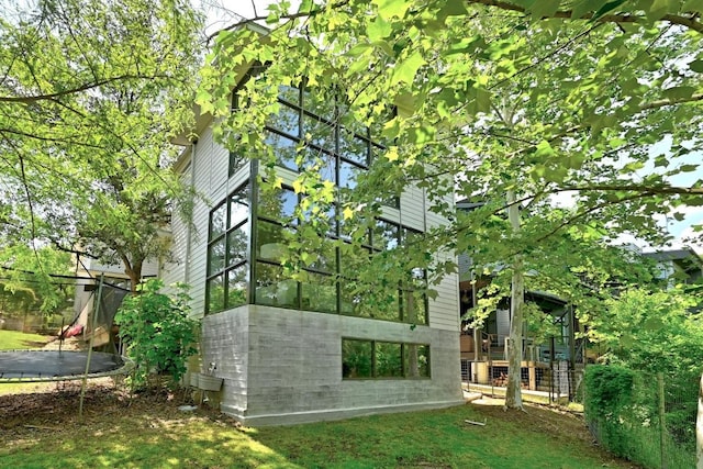 1700 S 6th St, Austin, TX 78704 - view of home's exterior with a trampoline and a yard