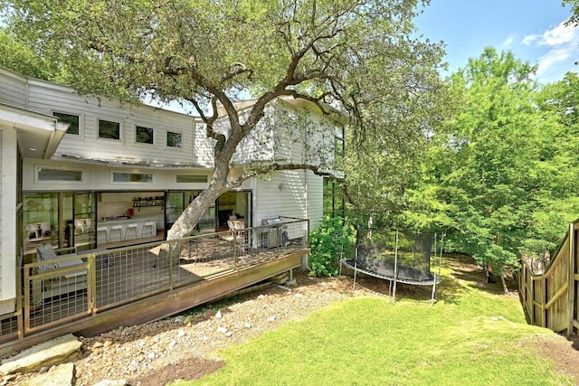 1700 S 6th St, Austin, TX 78704 - view of grassy yard with a trampoline and a deck