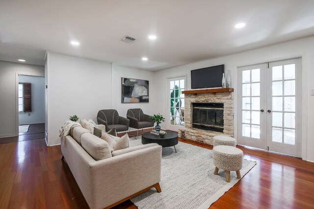 1005 Salem Ln, Austin, TX 78753 - living room with dark wood finished floors, recessed lighting, a fireplace, and french doors