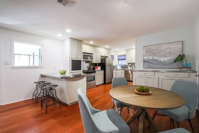 1005 Salem Ln, Austin, TX 78753 - kitchen featuring stainless steel appliances, plenty of natural light, a peninsula, white cabinets, and recessed lighting