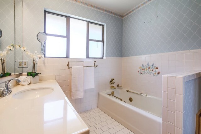 1005 Salem Ln, Austin, TX 78753 - bathroom with a jetted tub, tile walls, tile patterned flooring, and vanity