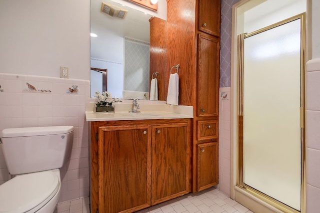 1005 Salem Ln, Austin, TX 78753 - bathroom with toilet, vanity, a stall shower, tile walls, and tile patterned floors