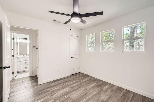 7103 Treasure Cv Unit B, Austin, TX 78745 - unfurnished bedroom featuring light wood-type flooring and ceiling fan