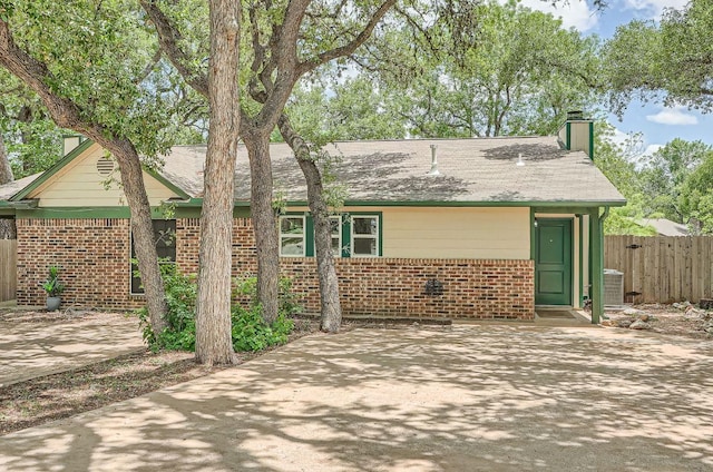 7103 Treasure Cv Unit B, Austin, TX 78745 - view of front of home featuring brick siding, a chimney, and a patio
