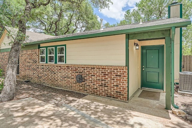 7103 Treasure Cv Unit B, Austin, TX 78745 - doorway to property featuring brick siding and a patio area